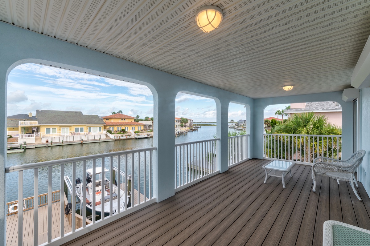 Take in stunning canal views from your covered balcony, where palm trees sway and boats drift by. Relax in cozy seating and watch the waterfront come alive.