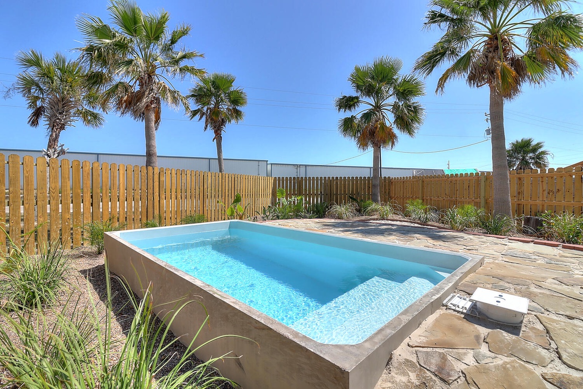 Slip into your private pool surrounded by swaying palms and natural stone - your tropical oasis awaits.
