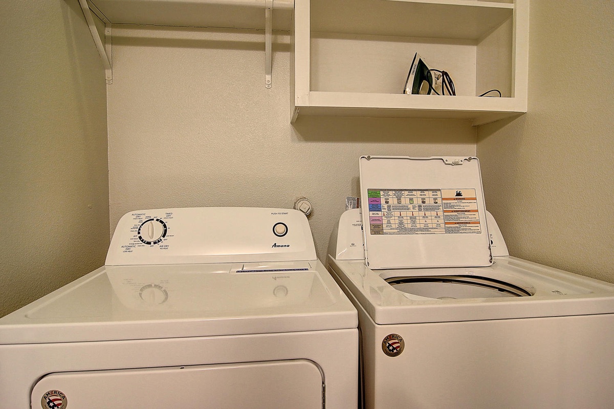 Keep your wardrobe fresh in this convenient laundry room with full-size washer and dryer, plus storage shelving for all your supplies.