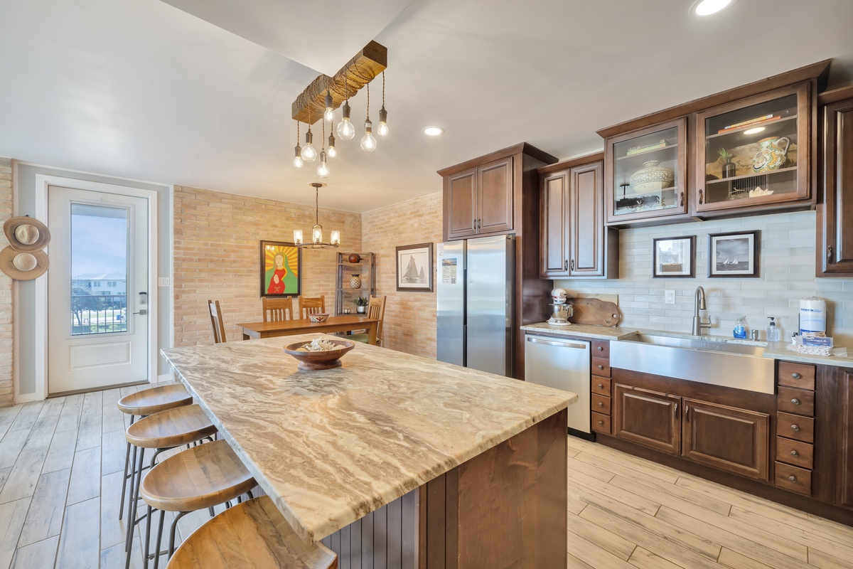 Your gourmet kitchen features rich wood cabinetry, granite countertops, and stainless steel appliances—perfect for preparing memorable meals together.