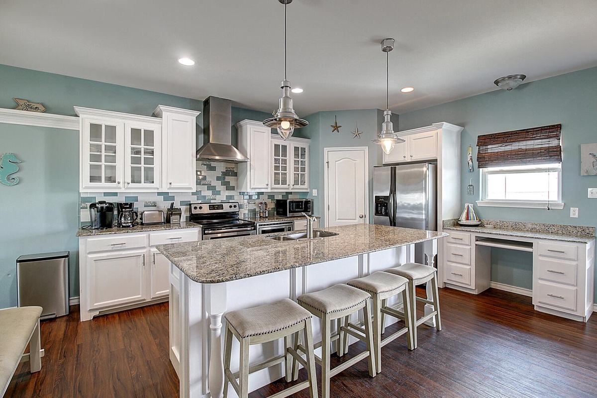 Your fully equipped kitchen features granite countertops, stainless steel appliances, and a spacious island where you can gather for meals and conversation.