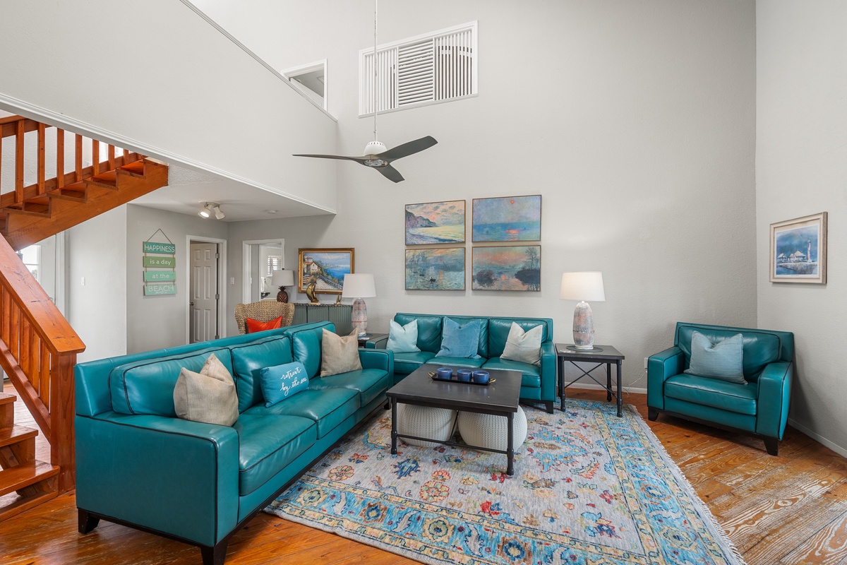Settle into this airy living space with soaring ceilings and turquoise leather seating. The open layout invites you to relax after beach days, with plenty of room to unwind together.