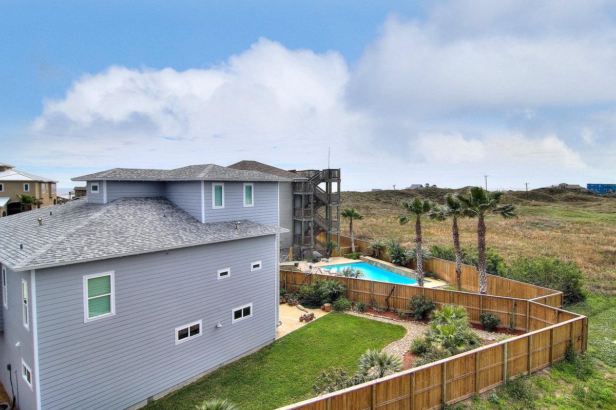 Modern coastal home with private pool and spacious yard set in peaceful natural surroundings.