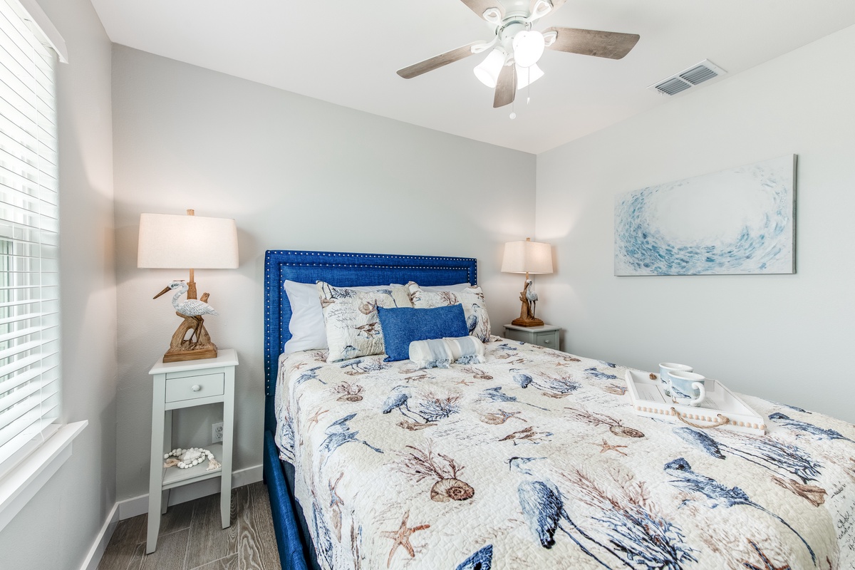 Drift off to sleep in your serene coastal bedroom, where ocean-themed bedding and soothing blue hues create the perfect retreat.