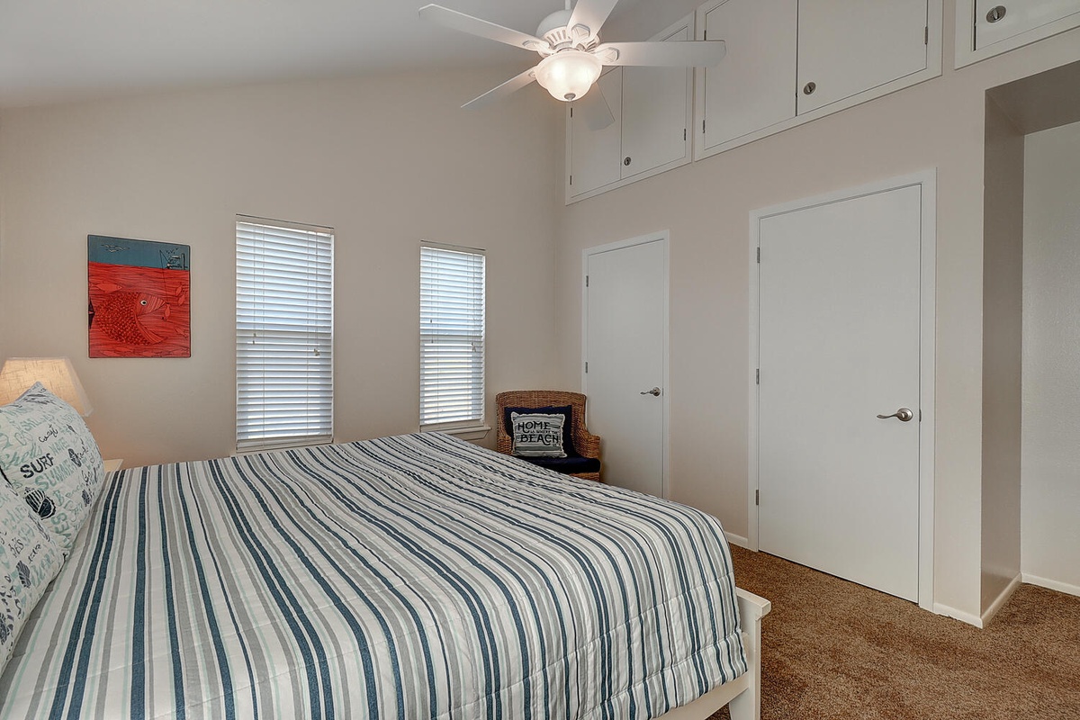 Drift off in your coastal-inspired bedroom, where nautical stripes and soft lighting create the perfect beach retreat atmosphere.