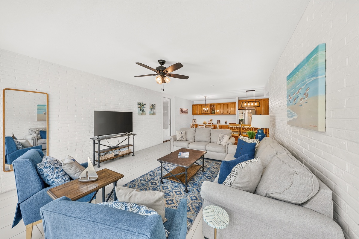 Sink into plush seating and let coastal breezes flow through your open living space, complete with a fully equipped kitchen ready for your culinary adventures.