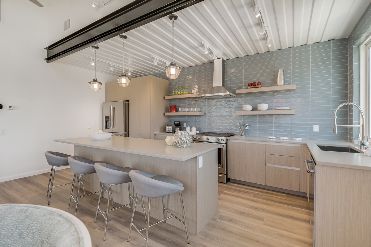 Cook memorable meals in your stunning modern kitchen featuring sleek countertops, professional appliances, and stylish pendant lighting.