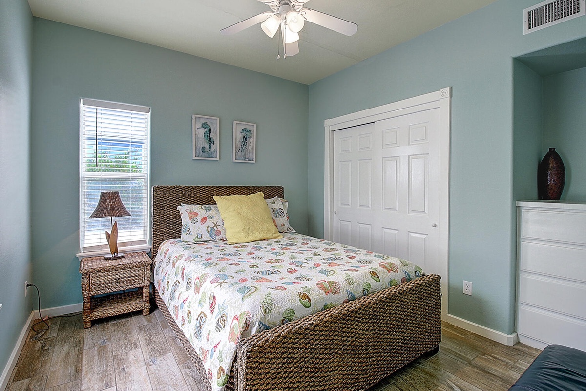 Drift off in your coastal bedroom with soft aqua walls, wicker furnishings, and whimsical sea life bedding.