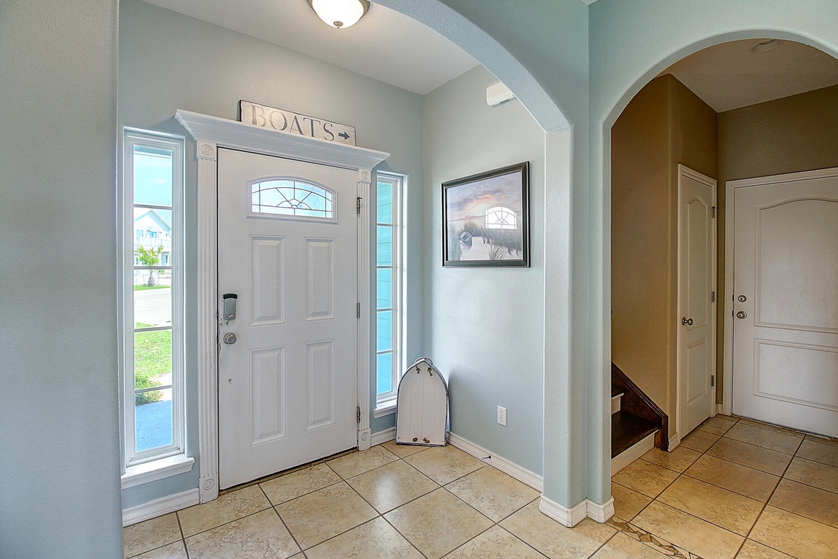 Step into your peaceful coastal retreat through this welcoming entryway, where charming nautical touches and serene blue walls set the tone for relaxation.