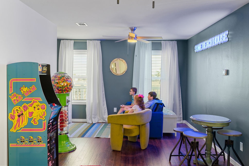 Your family's perfect game room awaits with vintage arcade machines, colorful seating, and endless entertainment possibilities.