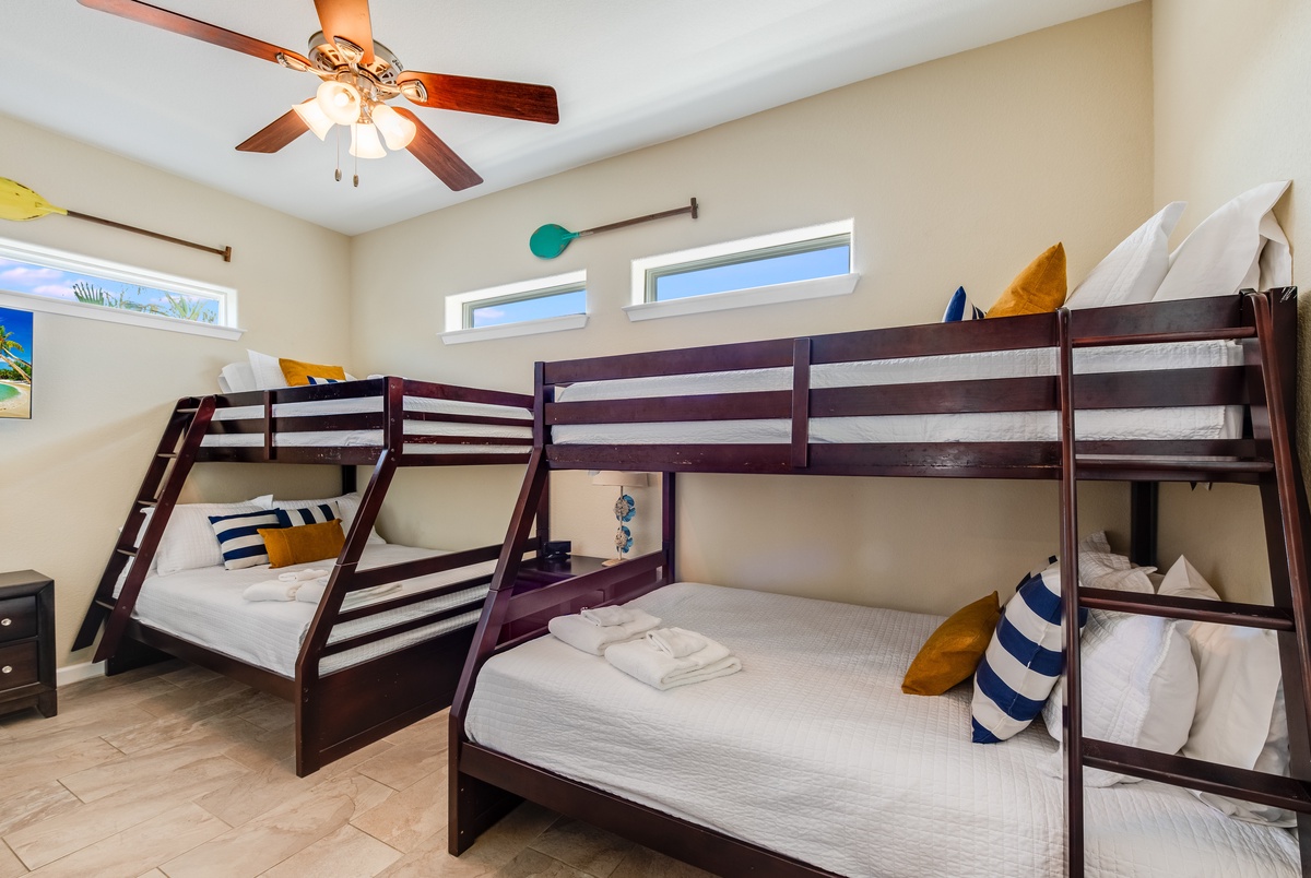 Your family's perfect sleep sanctuary with twin bunk beds, ceiling fan comfort, and nautical touches throughout this bright, welcoming room.