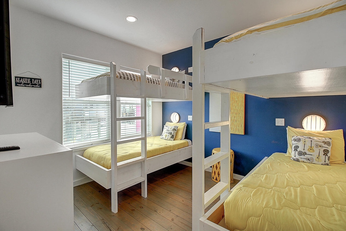 Your kids will love this nautical-themed bunk room with cheerful yellow bedding and fun maritime details.