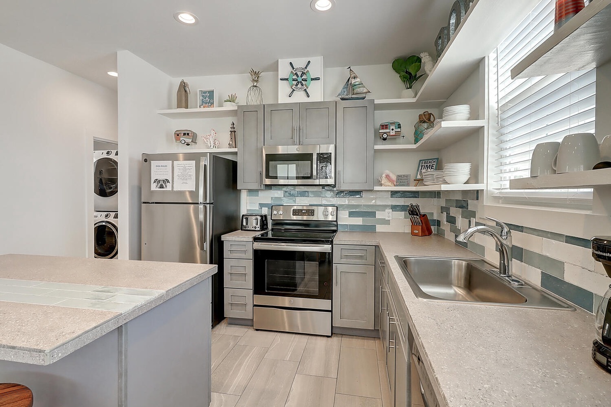 Your fully equipped kitchen awaits with stainless appliances, coastal charm, and everything you need to create memorable meals during your stay.