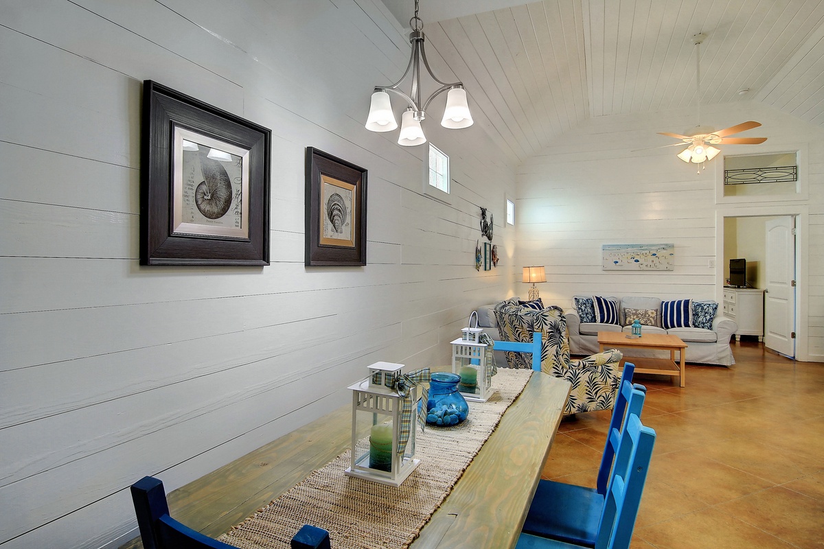 Gather around this inviting dining table where coastal charm meets comfort - your perfect spot for morning coffee and evening conversations.
