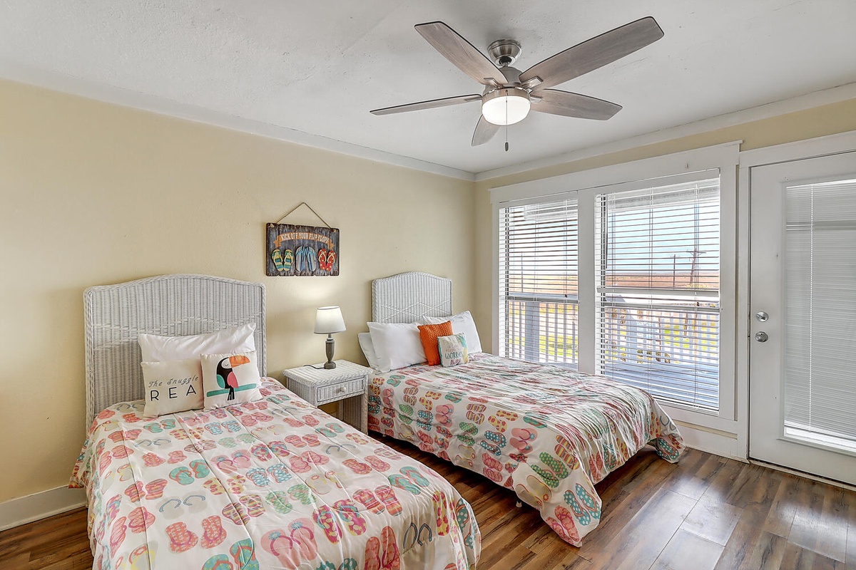 Drift off in these twin beds with coastal charm, where morning sunlight and gentle ceiling fan breezes create your perfect seaside retreat.