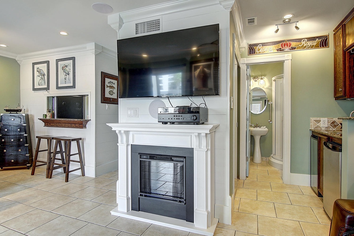 Relax by your cozy fireplace while watching your favorite shows on the large flat-screen TV in this thoughtfully designed living space.