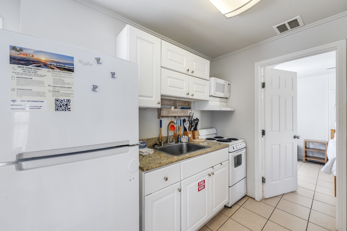Your fully equipped kitchen awaits with everything needed to prepare meals, featuring granite counters and modern appliances for convenient home-style cooking.