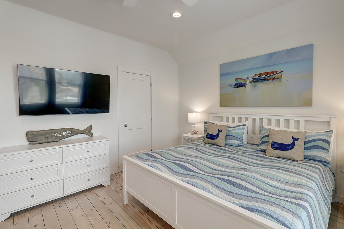 Drift off in this coastal-themed bedroom where nautical art and ocean-inspired linens create your peaceful seaside retreat.