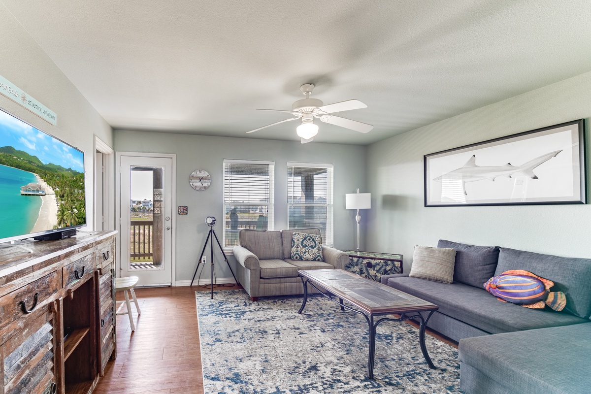 Unwind in your coastal-inspired living space, complete with comfortable seating and entertainment center for relaxing evenings after beach adventures.