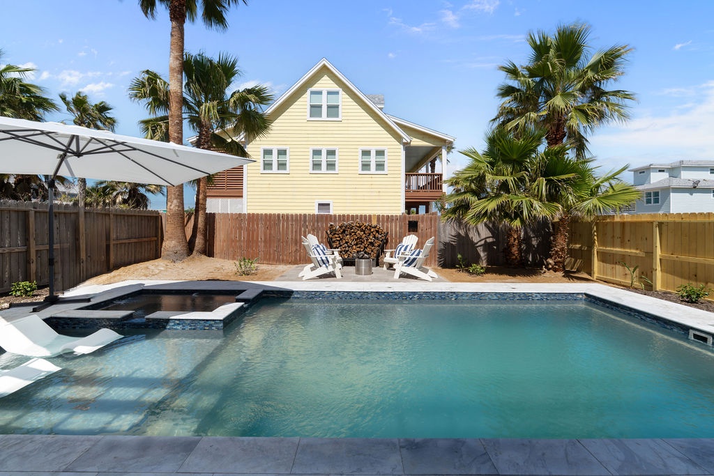 Dive into your private tropical oasis with crystal-clear pool waters, swaying palms overhead, and loungers waiting for your afternoon relaxation.