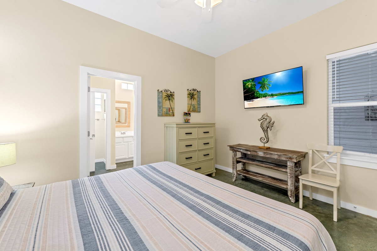 Unwind in your coastal-themed bedroom with tropical beach scenes on the wall-mounted TV and charming nautical decor throughout.
