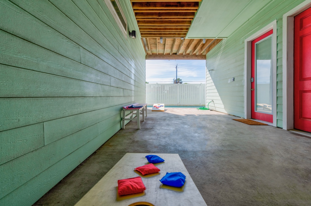 Your private covered patio offers space to relax with colorful bean bags and games, perfect for family fun.