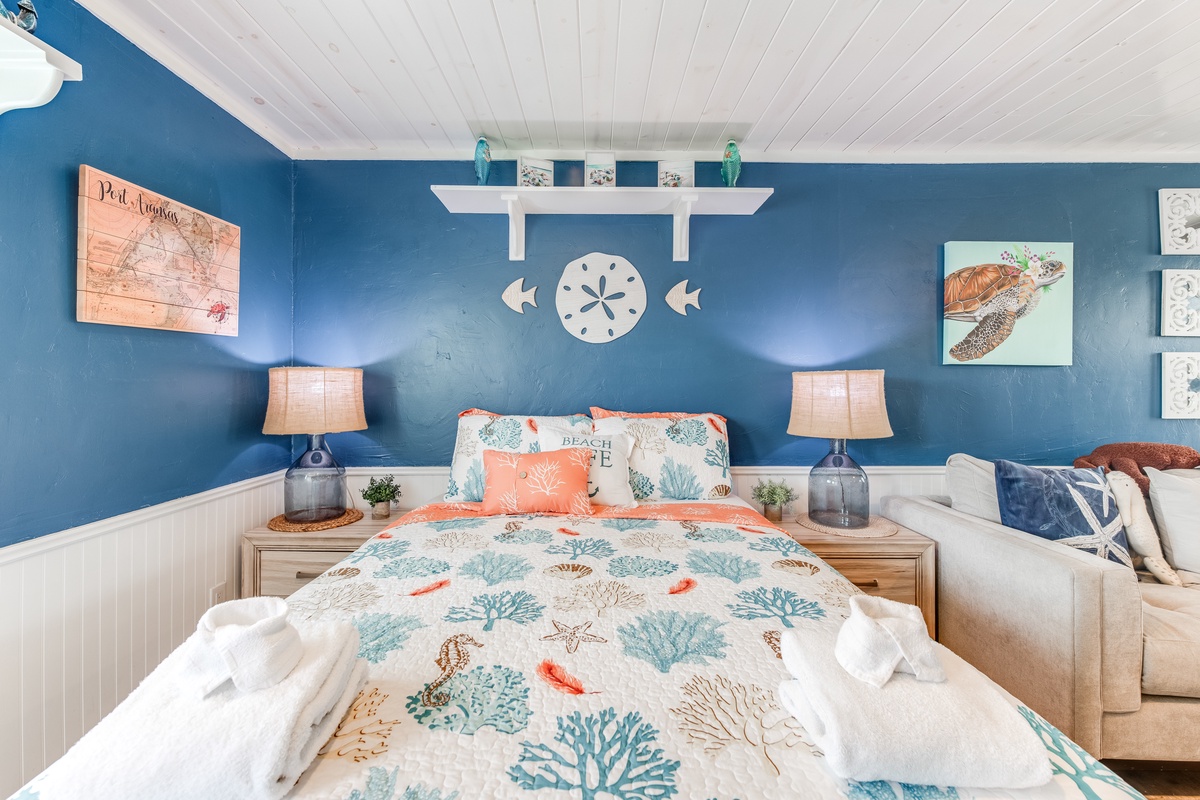 Drift into coastal dreams in this ocean-themed bedroom where nautical blues and coral prints create your perfect seaside sanctuary.