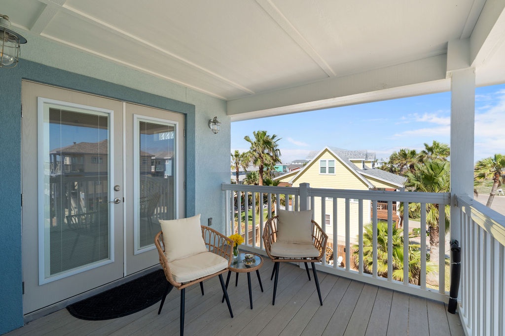 Step onto your private covered balcony and settle into comfortable seating while enjoying tropical palm views.