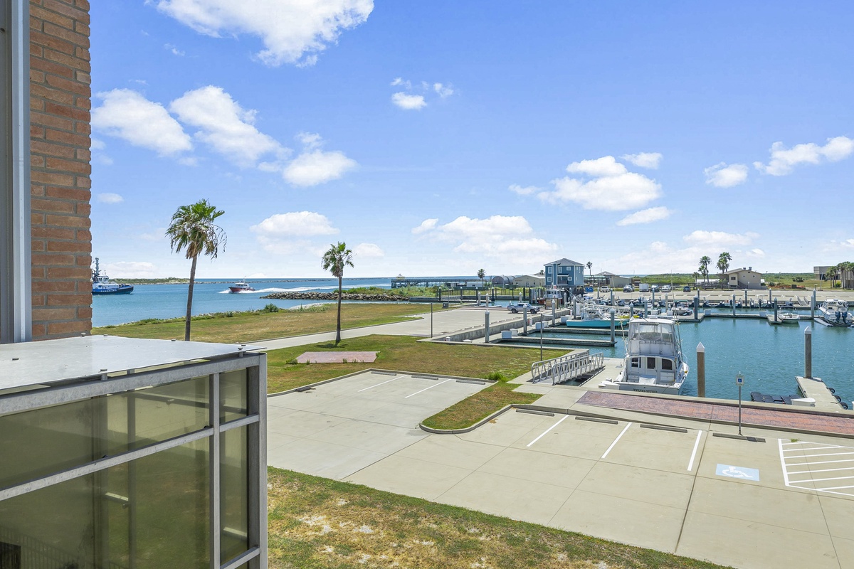 Waterfront marina setting with boats, palm trees, and coastal views creating a peaceful seaside atmosphere.
