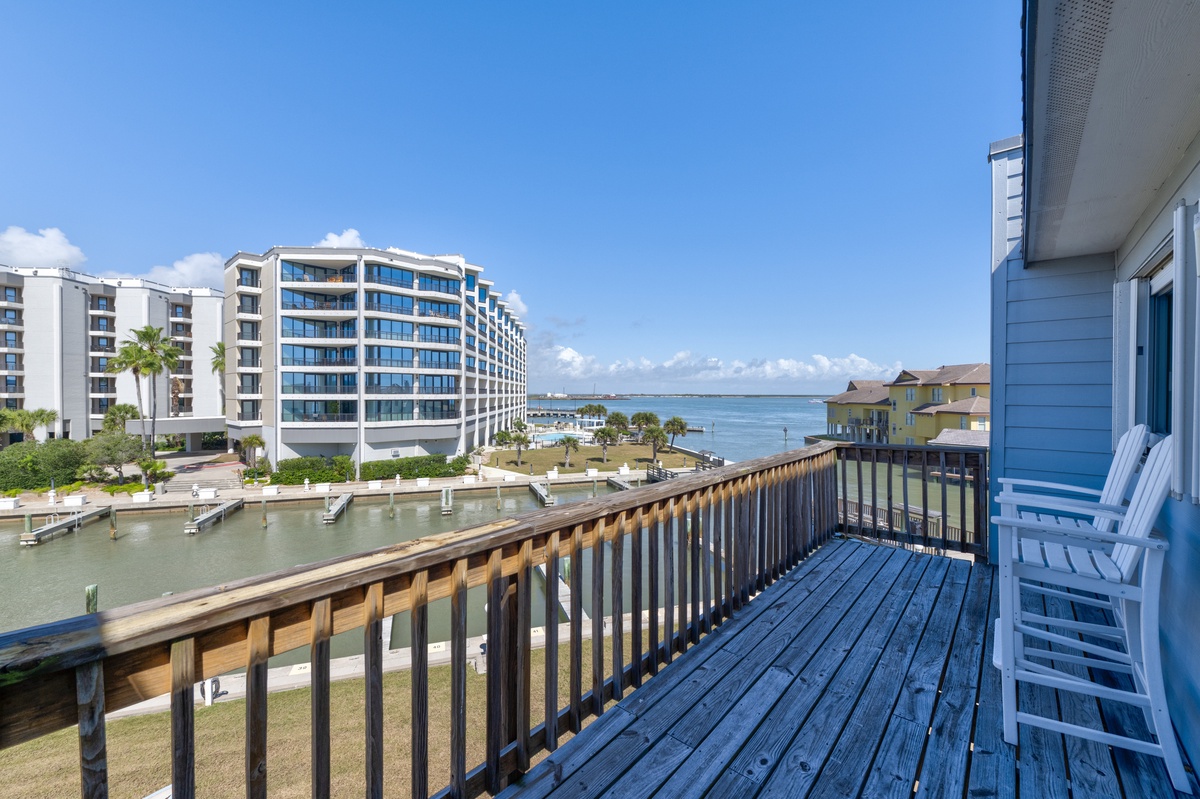 Step onto your private balcony and soak in stunning water views. White chairs await for morning coffee or sunset relaxation overlooking the peaceful marina.