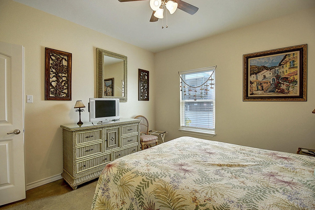 Drift into peaceful sleep in your charming bedroom, complete with cozy bedding, thoughtful artwork, and gentle natural light streaming through your window.