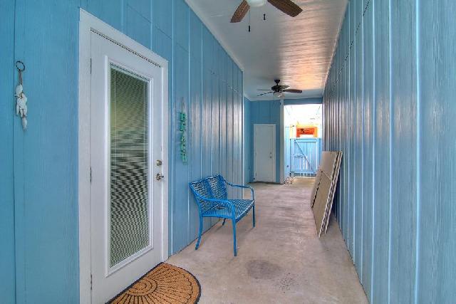 Your private breezeway connects indoor comfort with coastal charm, featuring turquoise walls and tropical touches.