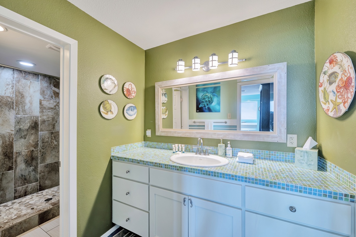 Your spa-like bathroom features vibrant green walls and turquoise tile accents, creating a refreshing oasis for your morning routine.