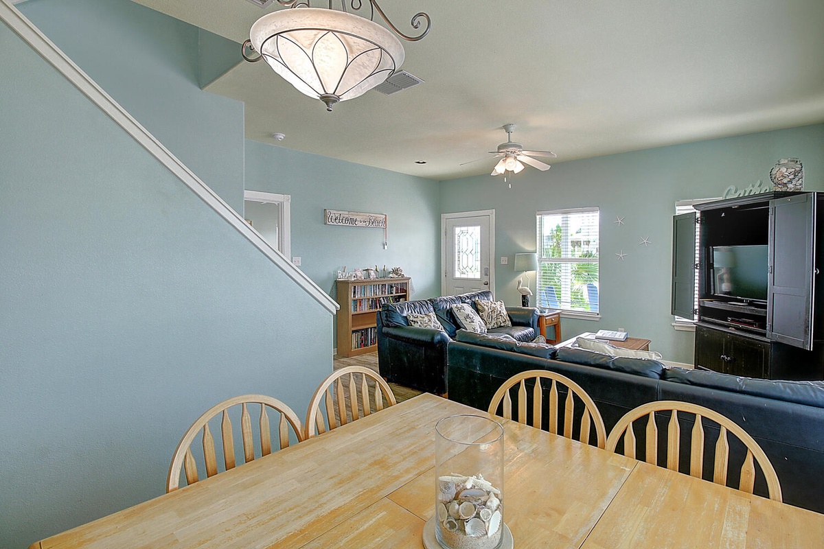 Gather around your dining table for family meals, then unwind in the cozy living room with entertainment center and peaceful blue walls.