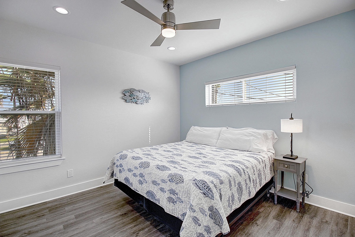 Drift off to sleep in your serene bedroom, where soft blue tones and natural light create the perfect peaceful retreat for restful nights.