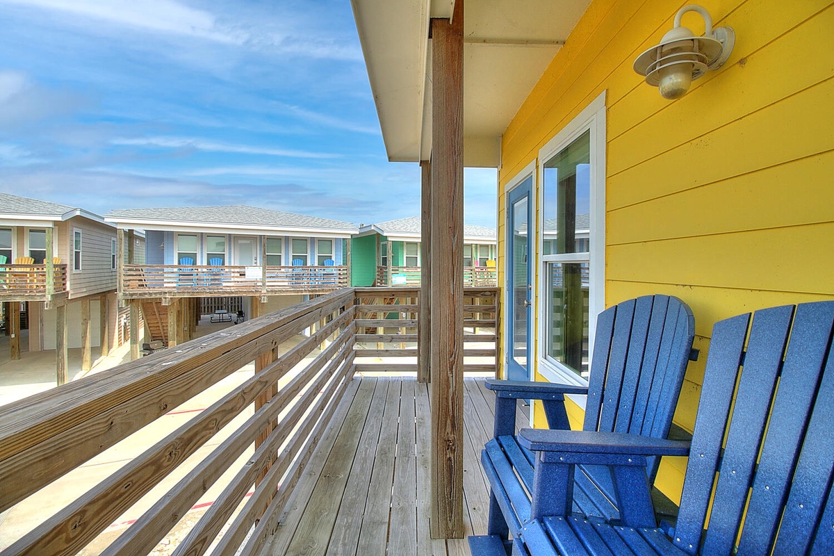Settle into your bright blue Adirondack chairs on your private deck, where morning coffee tastes better with ocean breezes and colorful beach house views.