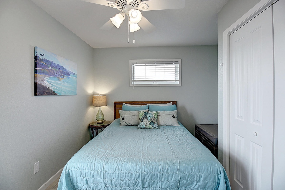 Slip into soft coastal dreams in your serene bedroom, where ocean artwork and soothing blues create the perfect sanctuary for restful nights.