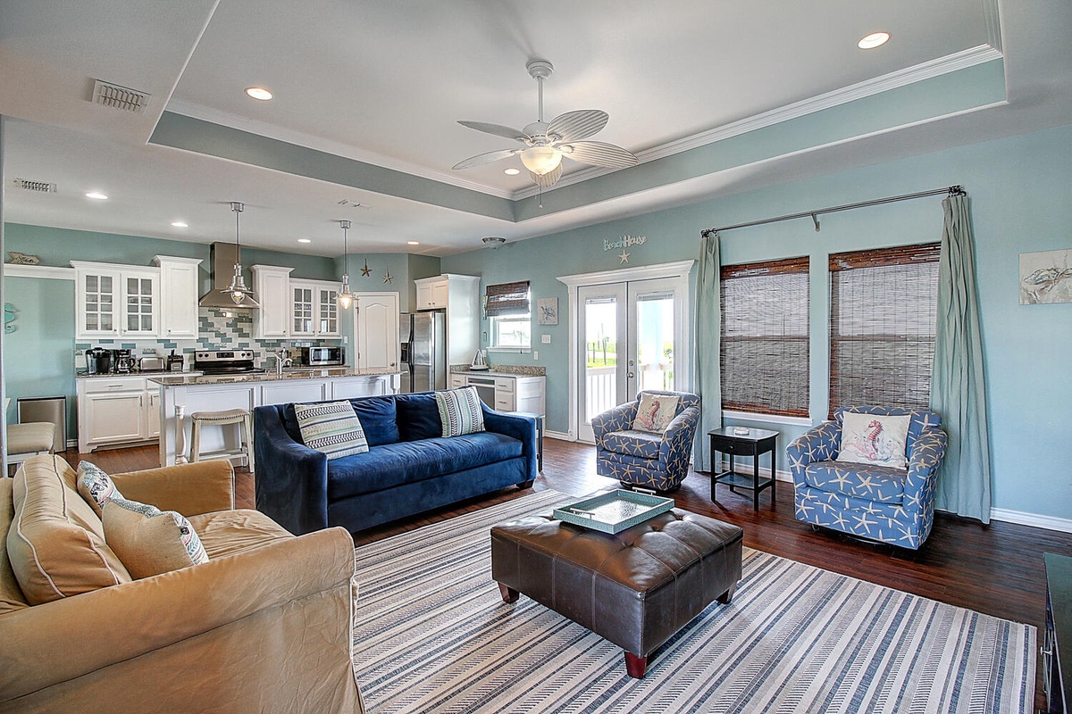 Unwind in your elegant coastal haven where calming blue walls meet sophisticated comfort. The open layout flows from kitchen to living space, perfect for gatherings.