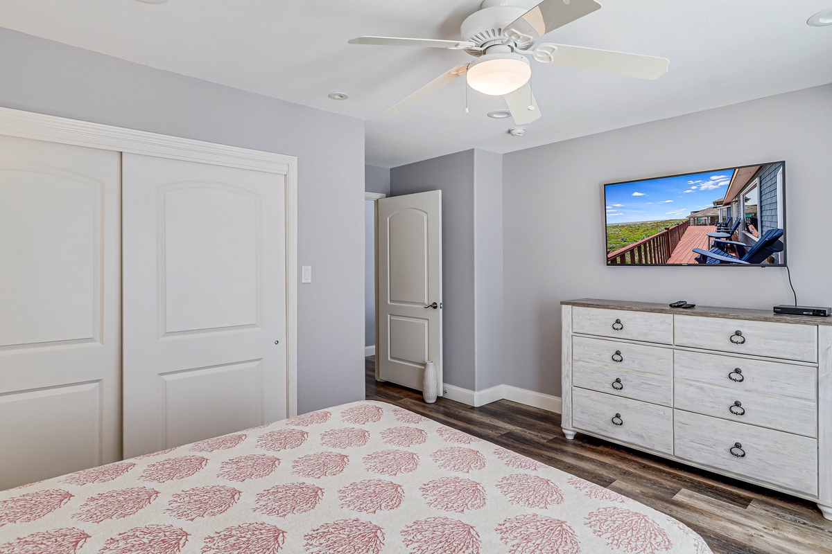 Unwind in your comfortable bedroom with soft lighting, ceiling fan, and TV for ultimate relaxation after your adventures.