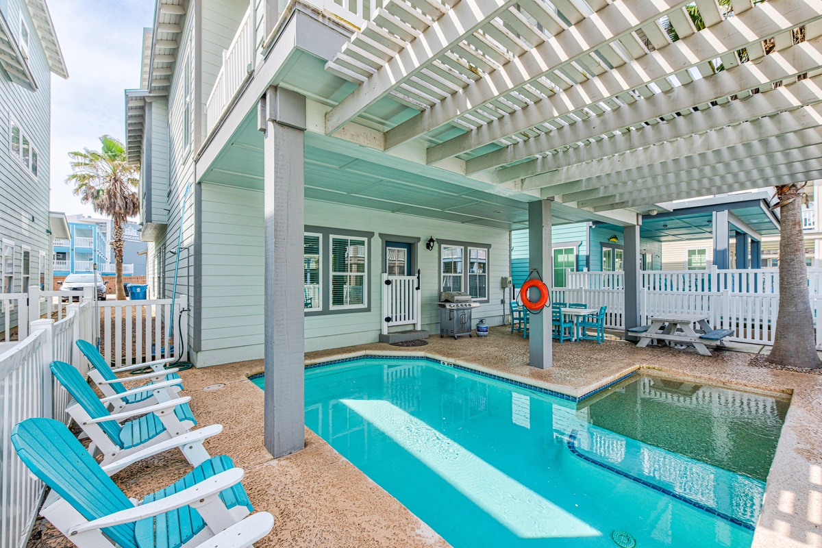 Dive into your private oasis with crystal-clear waters and coastal charm, perfectly framed by turquoise accents and shaded relaxation areas.