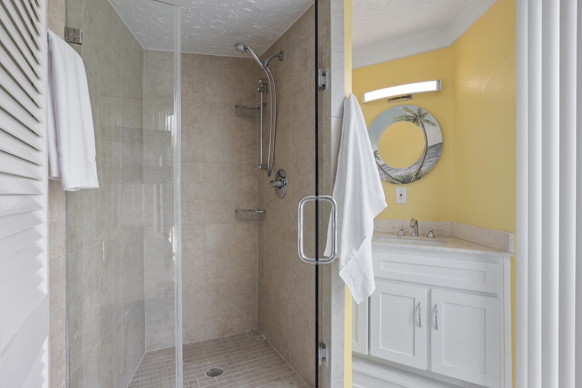 Step into your bright bathroom with modern glass shower, fresh towels, and coastal-inspired decor that makes every morning feel like vacation.