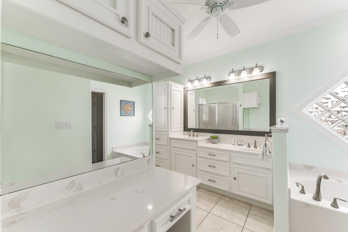 Unwind in your spa-like master bathroom with dual vanities, soaking tub, and serene mint walls that create the perfect retreat.