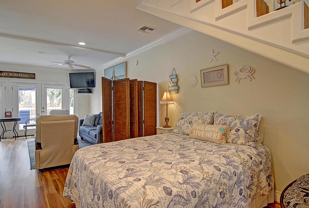 Your coastal-themed bedroom seamlessly flows into the open living space, creating a relaxing retreat with charming nautical touches and warm lighting.