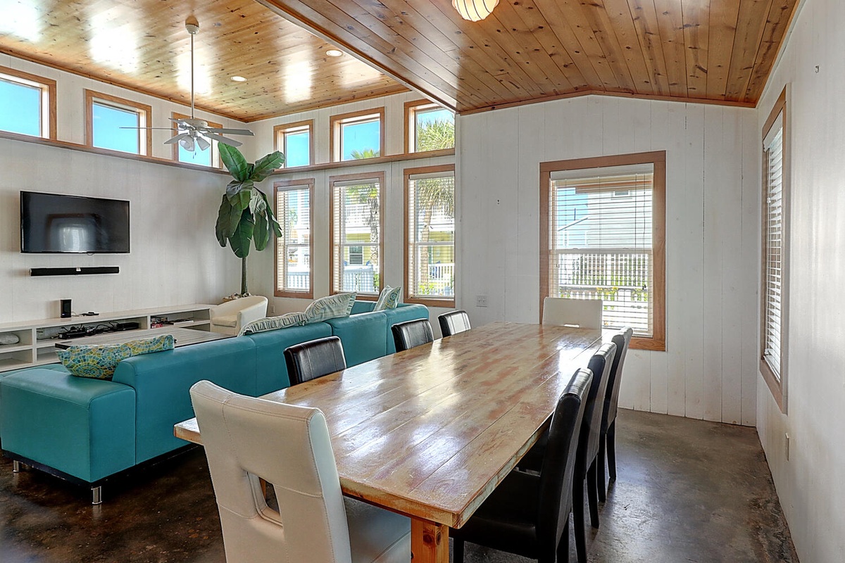 Gather around your spacious dining table while sunlight streams through soaring windows, creating the perfect spot for memorable meals together.