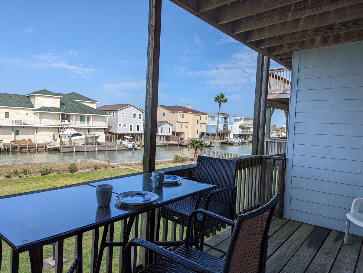Your private balcony overlooks peaceful waterfront homes and a canal, perfect for morning coffee with serene water views.