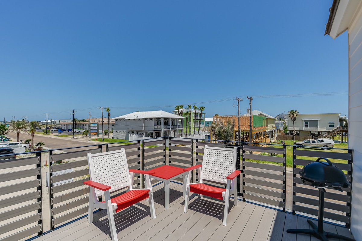 Relax on your private balcony with comfortable seating and enjoy morning coffee while taking in the neighborhood views.