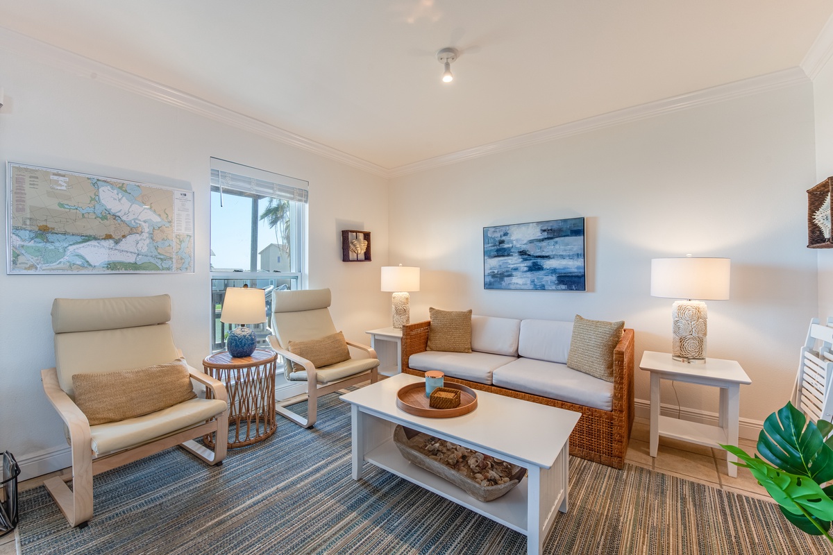 Sink into this coastal-inspired living room where nautical maps and ocean artwork create your perfect seaside retreat.