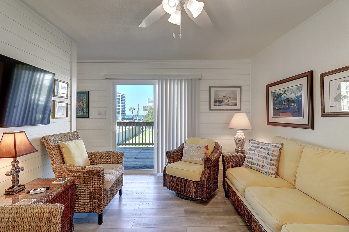Unwind in your coastal living room with wicker furniture, nautical artwork, and city views from your private balcony.