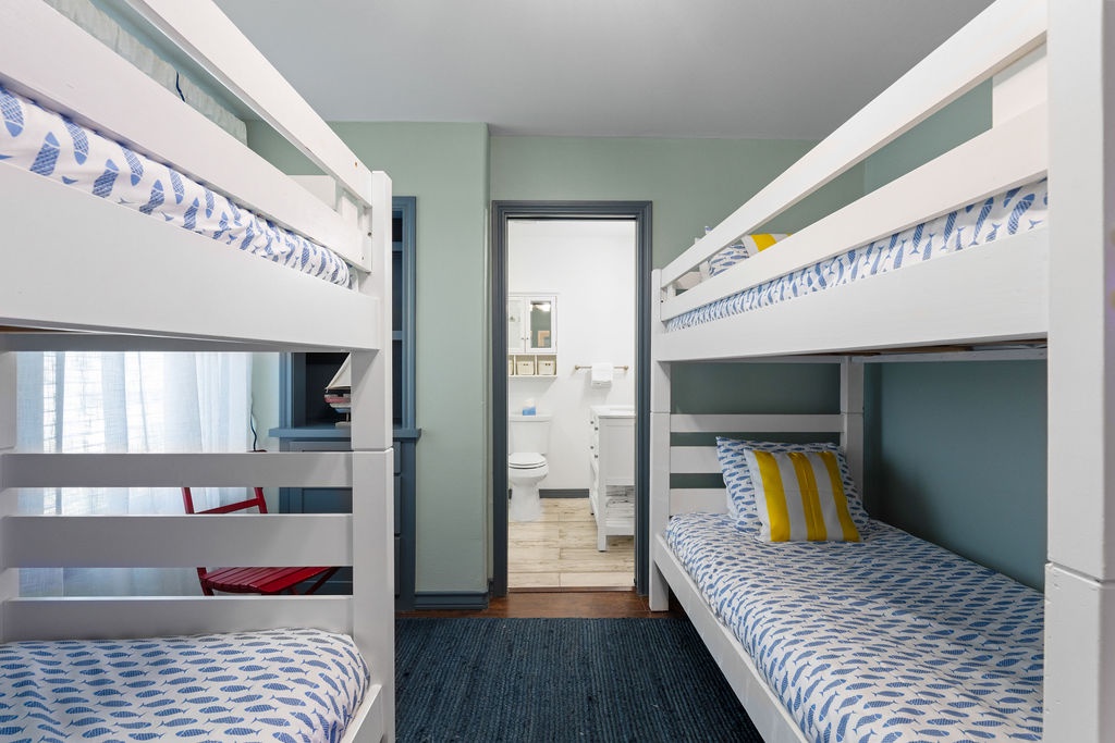 Sleep soundly in these cheerful bunk beds with soft blue linens and colorful accents. Perfect for family adventures.