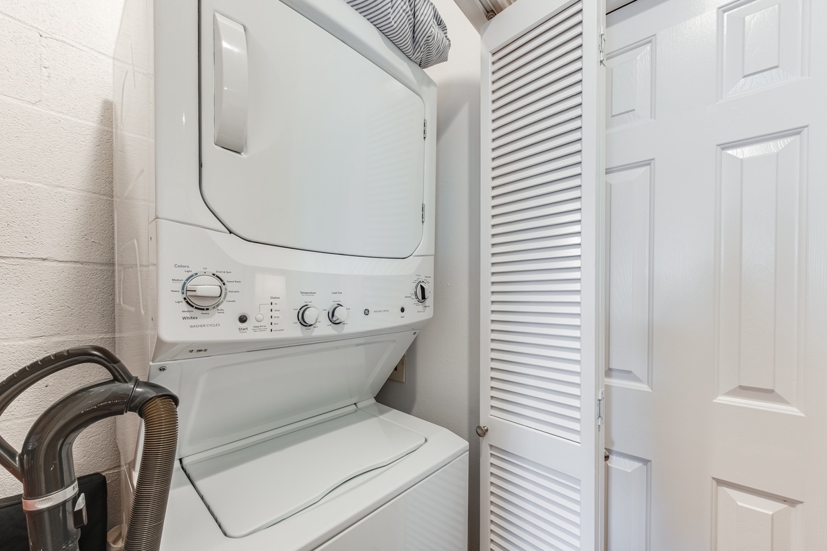 Handle your laundry needs with ease in this convenient in-unit washer and dryer setup tucked neatly behind stylish louvered doors.